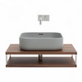Ceramic countertop basin with wood vanity and stainless steel faucet in grey